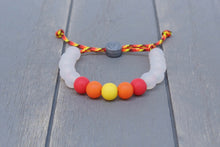 Load image into Gallery viewer, Translucent adjustable silicone bead bracelet on fire coloured paracord