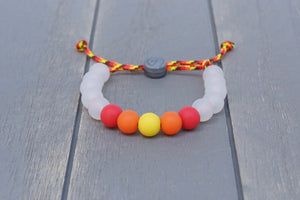 Translucent adjustable silicone bead bracelet on fire coloured paracord