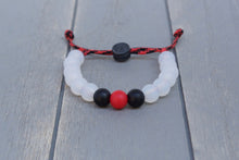 Load image into Gallery viewer, Translucent adjustable silicone bead bracelet on black and red paracord 