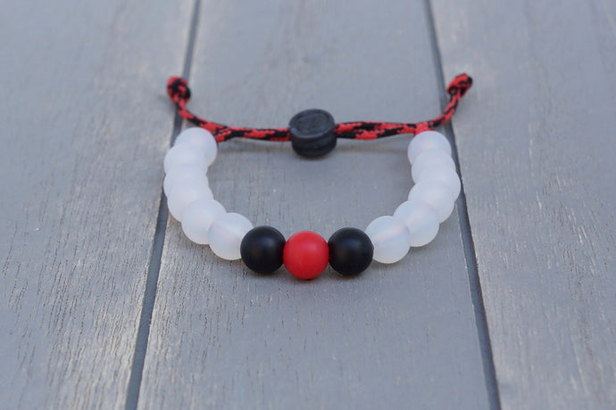 Translucent adjustable silicone bead bracelet on black and red paracord 