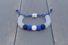 Load image into Gallery viewer, Translucent adjustable silicone bead bracelet on blue camo paracord