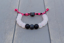 Load image into Gallery viewer, Translucent adjustable silicone bead bracelet on pink and black paracord