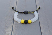 Load image into Gallery viewer, Translucent adjustable silicone bead bracelet on black and yellow paracord