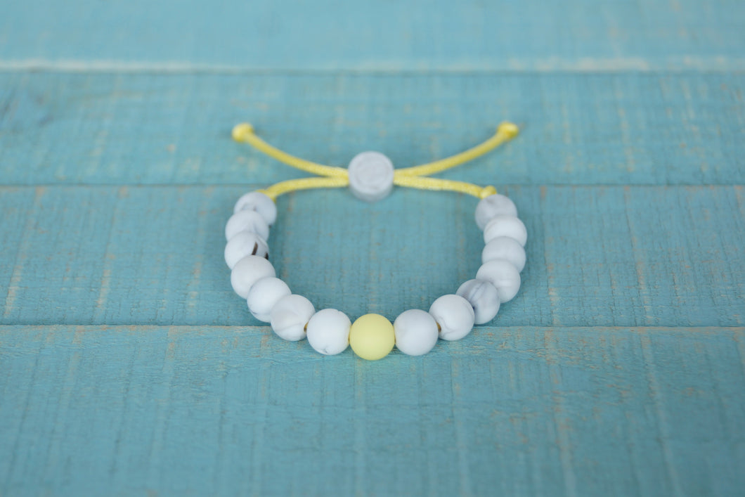 White Marble with yellow accent bead adjustable silicone bracelet