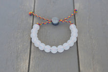 Load image into Gallery viewer, Translucent adjustable silicone bracelet on rainbow paracord