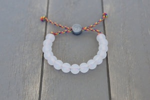 Translucent adjustable silicone bracelet on rainbow paracord