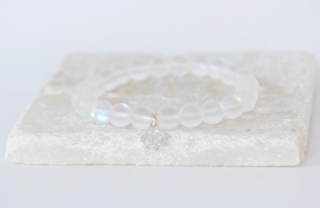White moonstone bracelet on elastic with silver tag