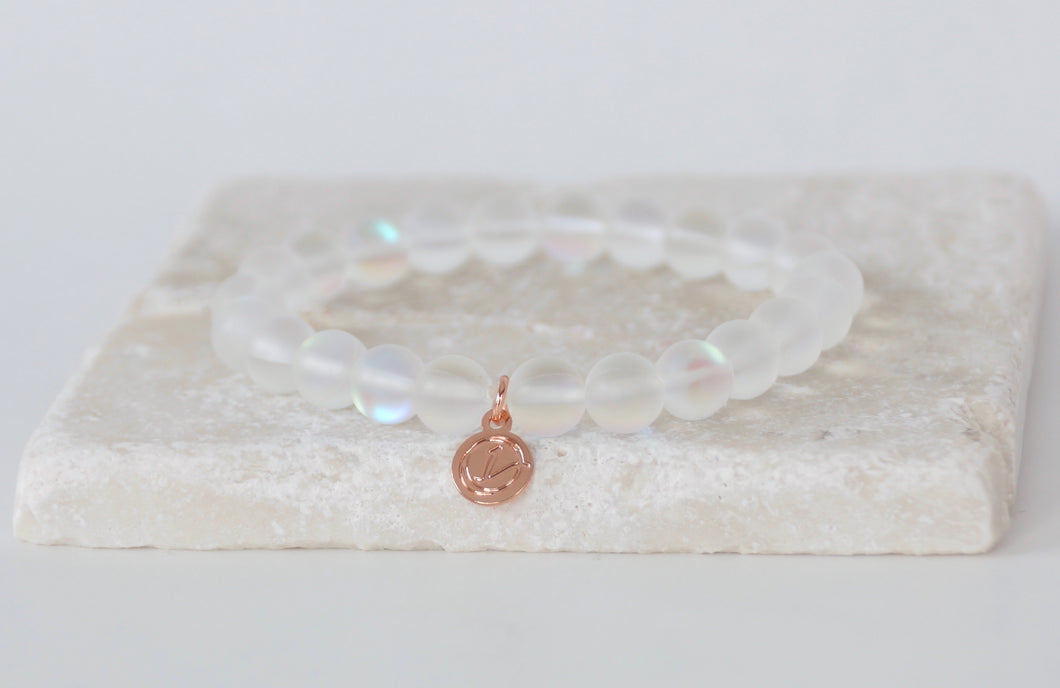 White moonstone bracelet on elastic with rose gold tag